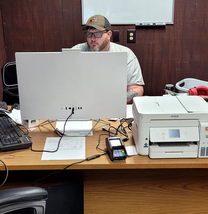 The front office desk with a computer, a printer and a card reader